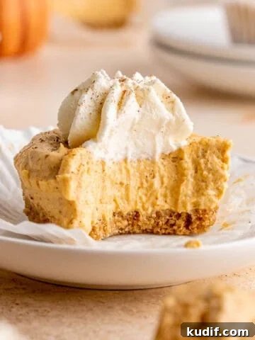 No bake pumpkin cheesecake with a bite taken out of it.