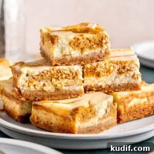 Pumpkin Cheesecake Bars Recipe for Fall Dessert Lovers 18 A stack of pumpkin cheesecake bars on a plate.