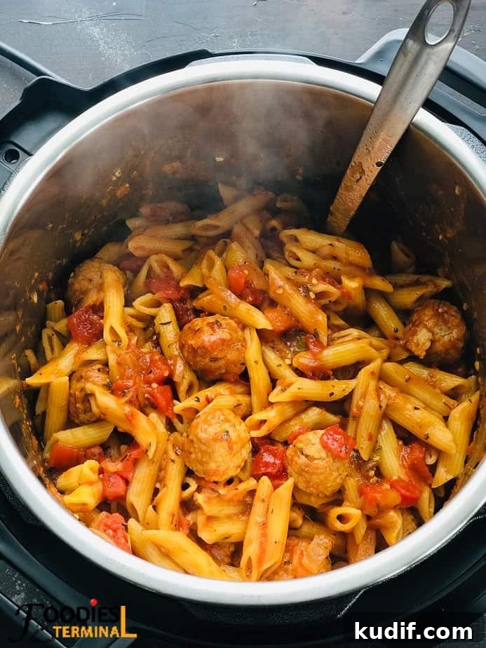 penne pasta and frozen meatballs in instant pot with a steel ladle