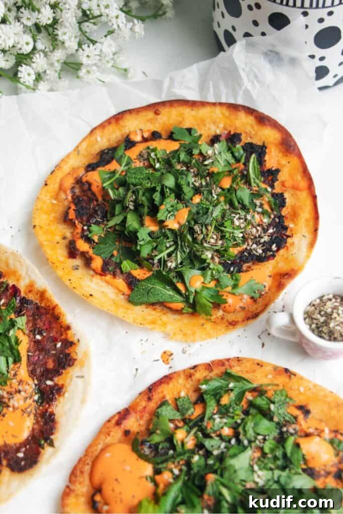 Smash Shrimp Toast Tacos — Crispy Prawn Toast Taco Recipe 11 Smash lahmacun taco with red pepper sauce and herby salad on top.