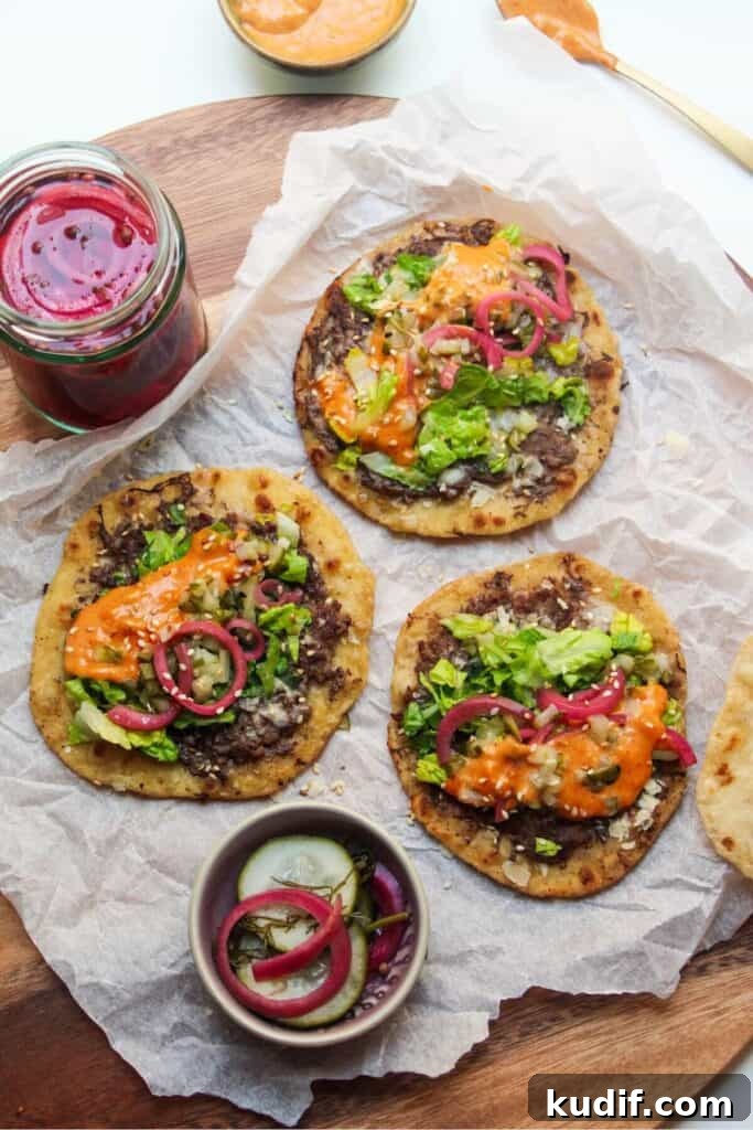 Smash Shrimp Toast Tacos — Crispy Prawn Toast Taco Recipe 13 3 Big Mac tacos on a baking paper lined wooden board, with pickles on the side.