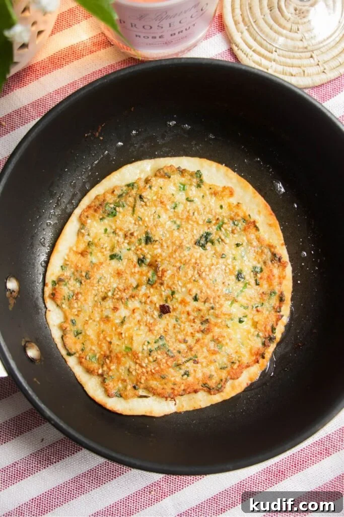 Smash Shrimp Toast Tacos — Crispy Prawn Toast Taco Recipe 7 Tortilla crisping up in a small pan.