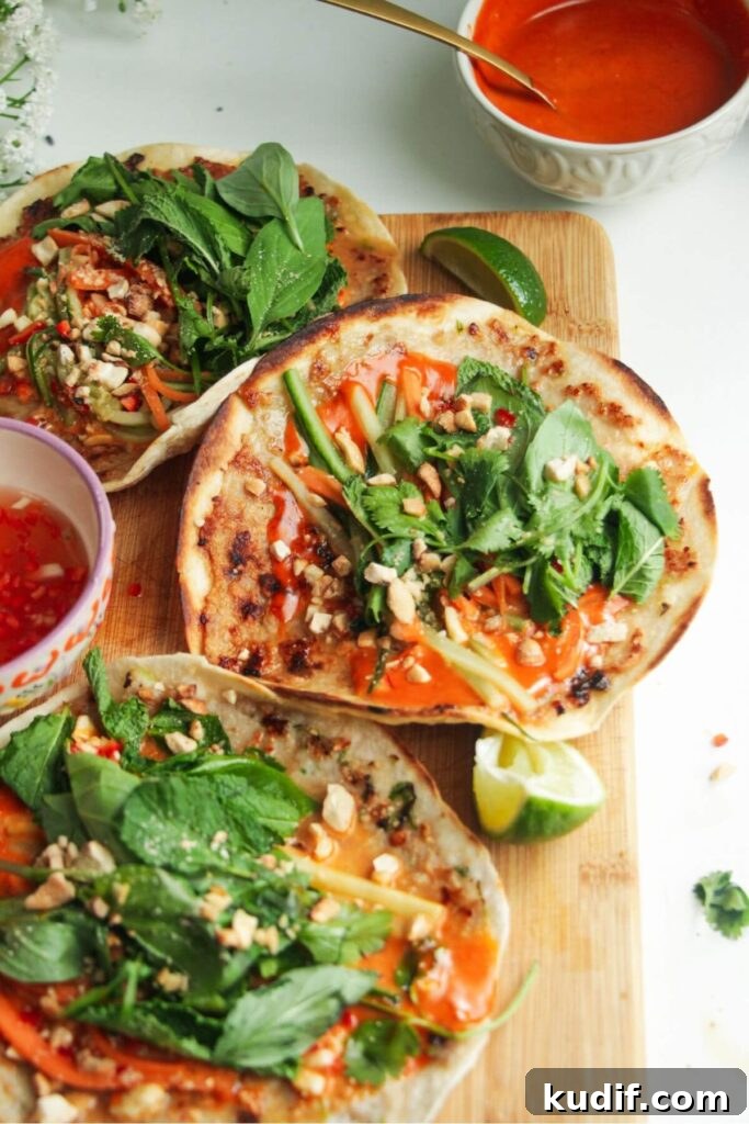 Smash Shrimp Toast Tacos — Crispy Prawn Toast Taco Recipe 10 Three chicken banh mi tacos on a wooden board.