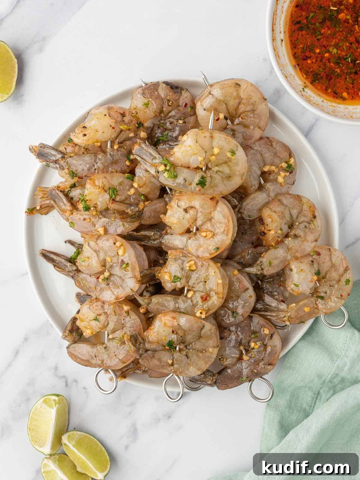 Garlic Grilled Shrimp Kabobs Recipe for Summer BBQ 5 Shrimp skewers with garlic shrimp marinade ready to be grilled.