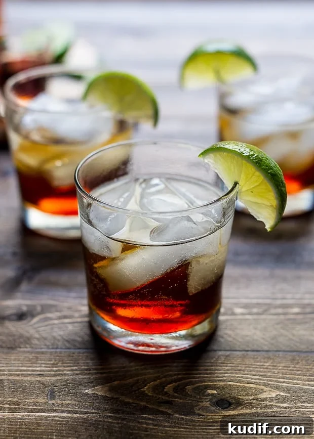 Pumpkin Spice Dark & Stormy Cocktail Recipe for Fall Nights 2 A Pumpkin Spice Dark and Stormy Cocktail on a wooden surface.