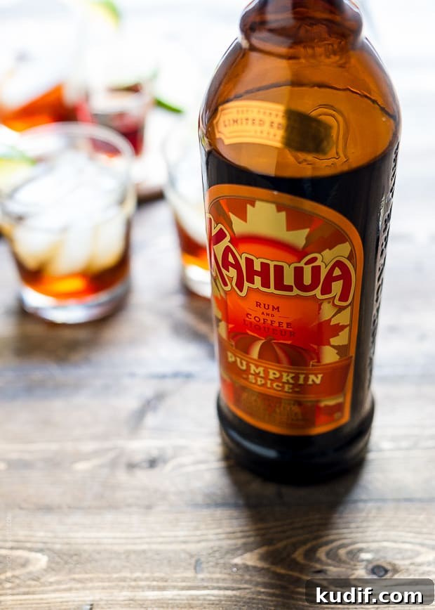 Pumpkin Spice Dark & Stormy Cocktail Recipe for Fall Nights 5 A bottle of Kahlua Pumpkin Spice on a wooden surface.