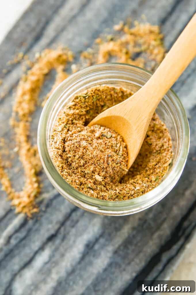 A jar full of seasoning with a wooden spoon in it.