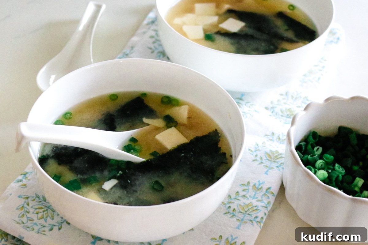 Authentic Homemade Miso Soup: Simple Traditional Recipe 11 Warm miso soup with seaweed and tofu served in a simple ceramic bowl.