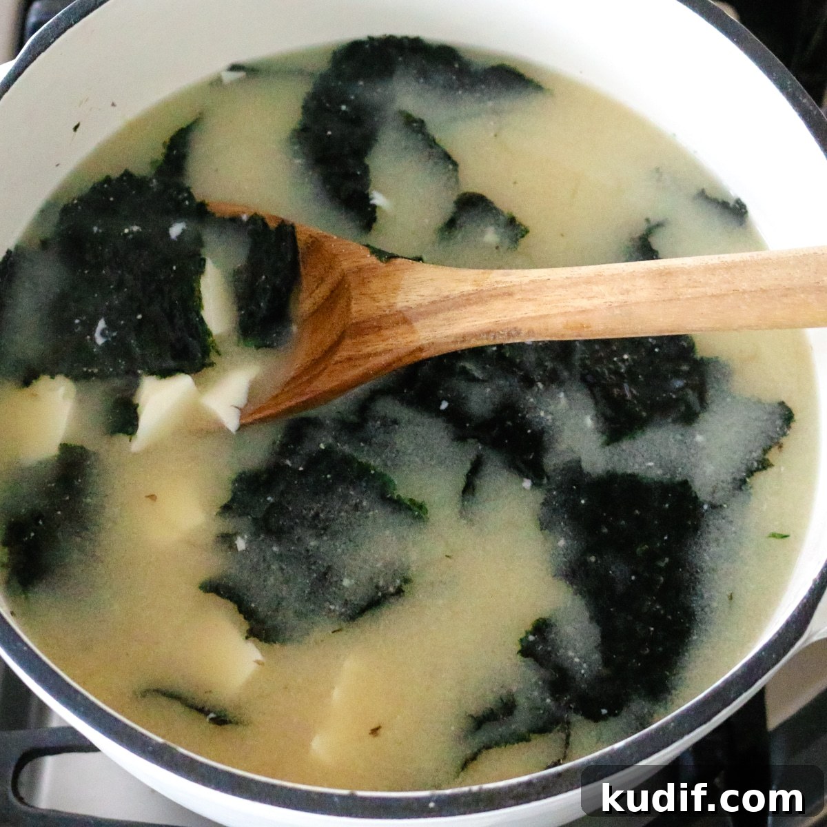 Authentic Homemade Miso Soup: Simple Traditional Recipe 10 Warm miso soup with seaweed and tofu served in a pot.