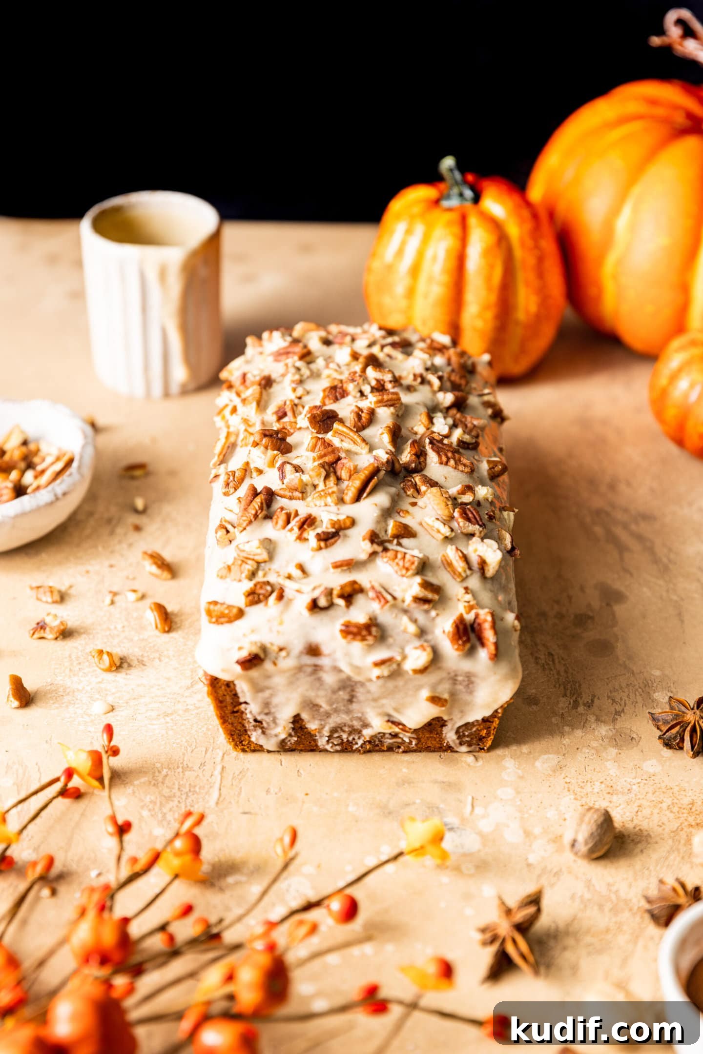 Maple-Glazed Pumpkin Bread Recipe for Fall Baking 4 Maple Glazed Pumpkin Bread with pecans on top