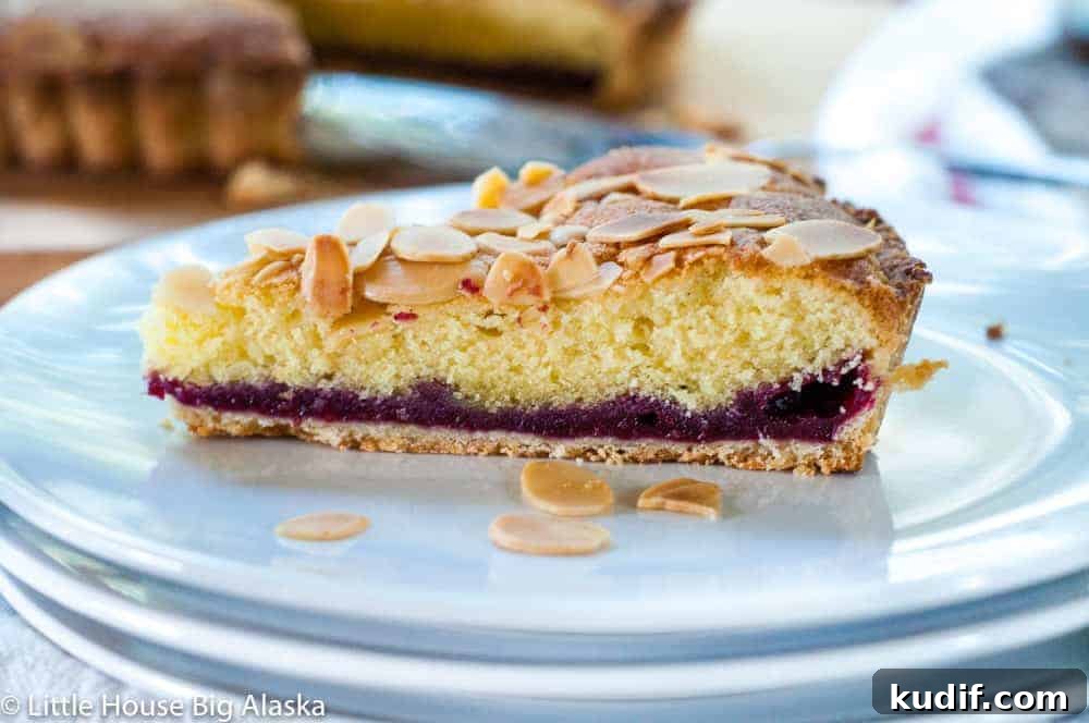 Quick Berry Desserts to Satisfy Sweet Cravings Fast 7 Slice of bakewell tart in a white plate.