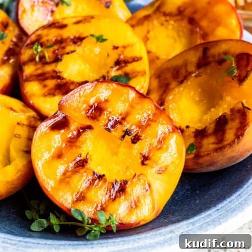 Grilled Peaches with Mascarpone and Honey Recipe 8 Close up shot of grilled peach on plate.