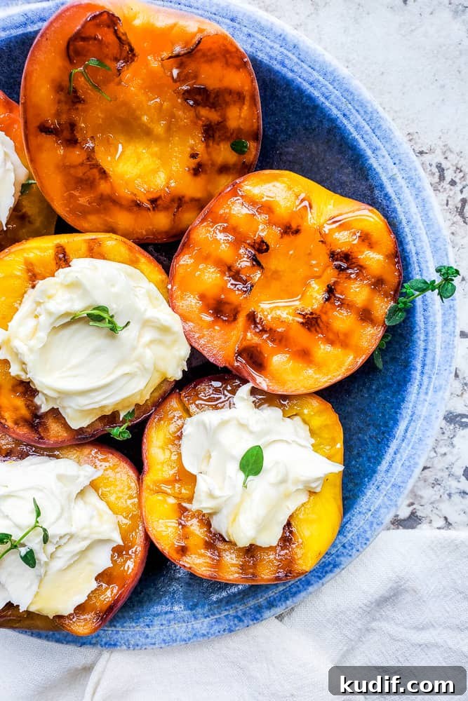 Grilled peaches with mascarpone and thyme Overhead shot of grilled peaches on a plate with mascarpone