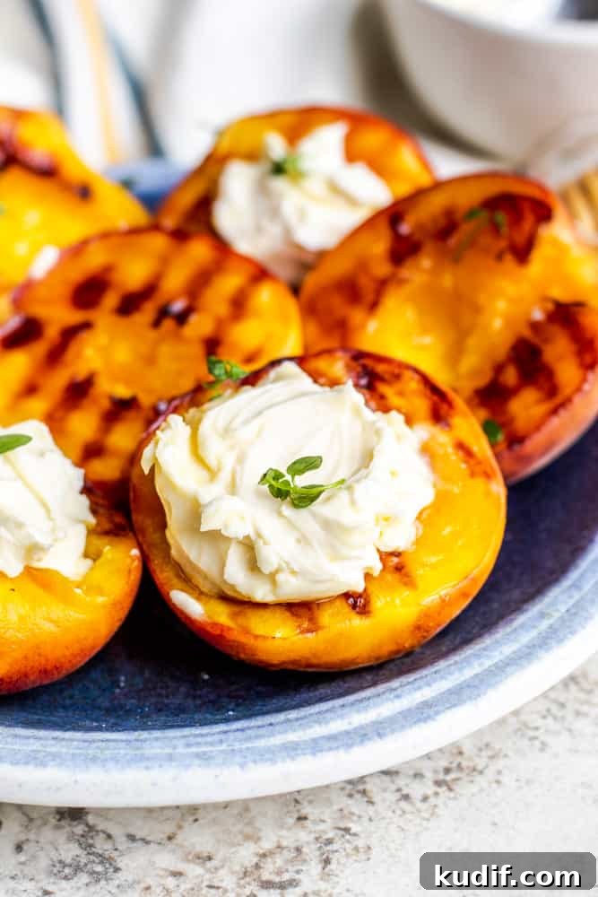 Grilled peaches topped with mascarpone and thyme Close-up of grilled peaches with mascarpone and thyme