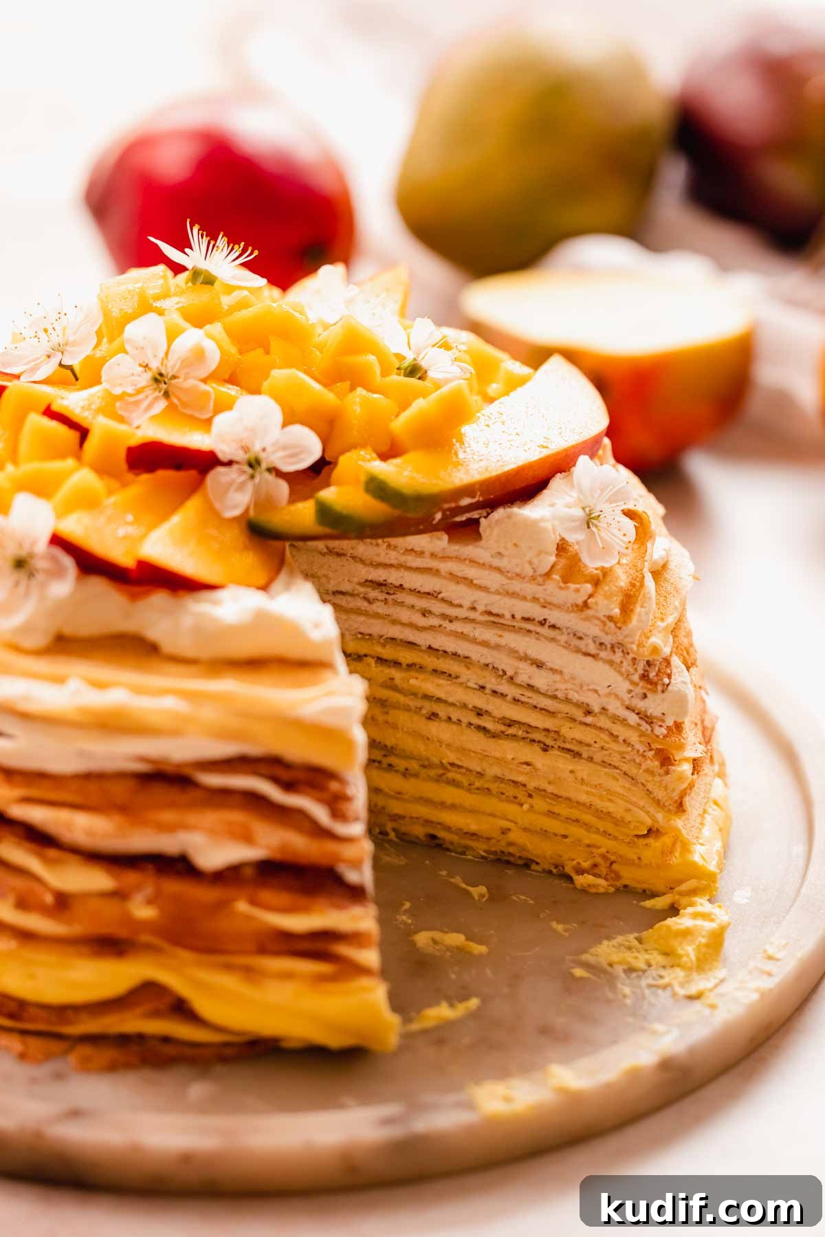 Mango Crepe Cake Recipe with Homemade Crepes Made from Scratch 19 close up of a mango crepe cake cut with layers inside