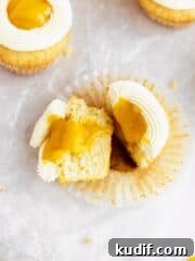 cut open mango cupcake filled with runny mango filling