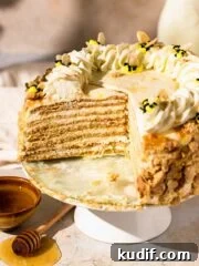 honey cake with lots of layers and piped bees on top