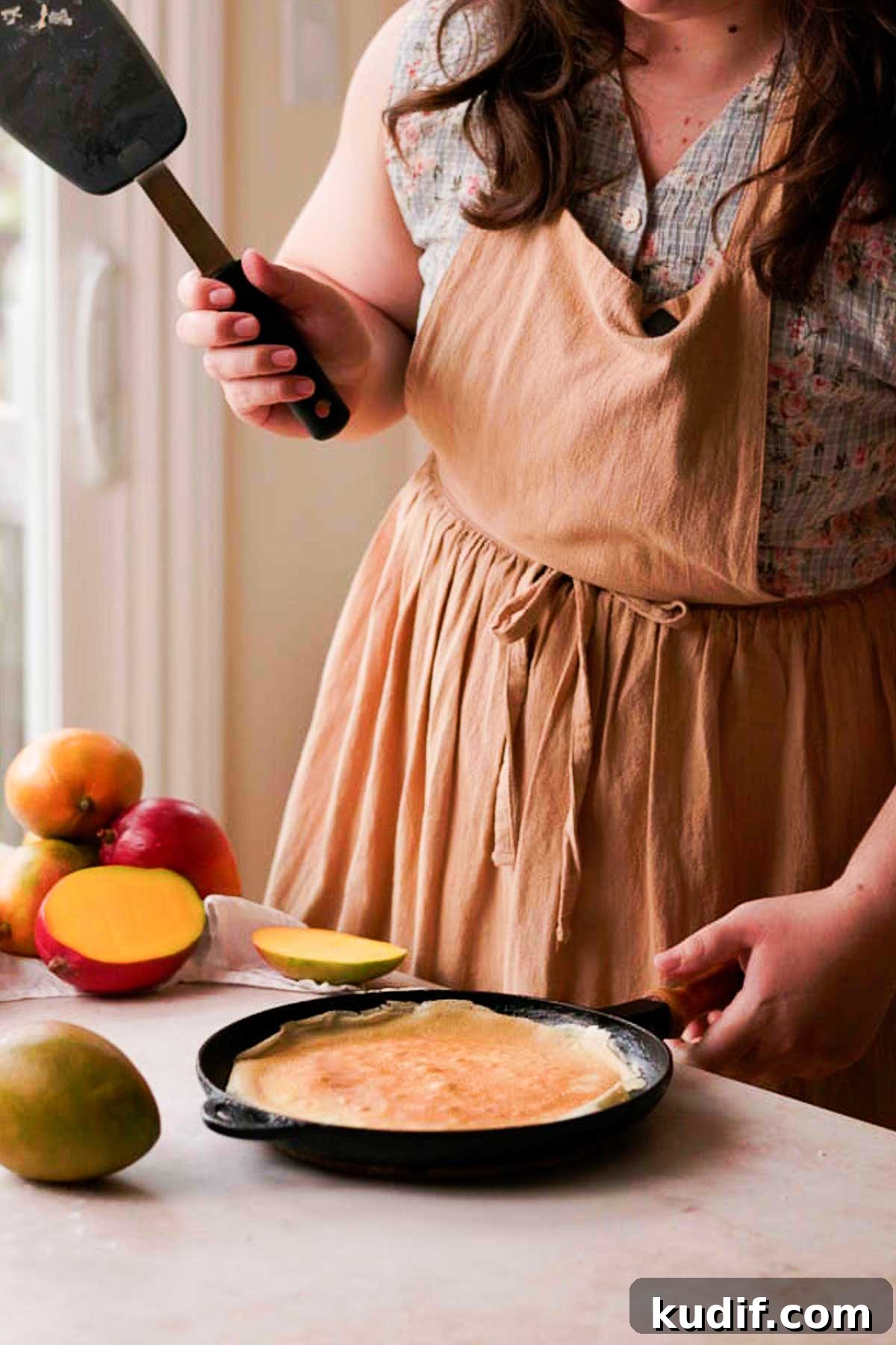 Mango Crepe Cake Recipe with Homemade Crepes Made from Scratch 8 a flipped crepe on a cast iron pan