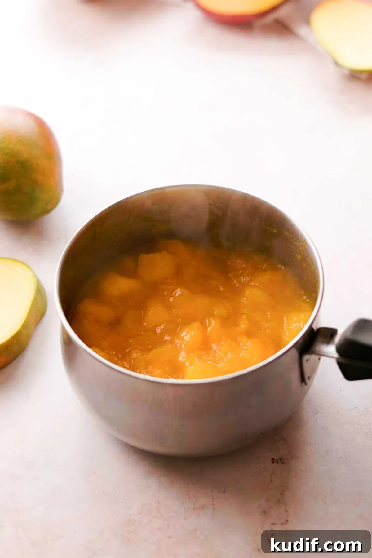 Mango Crepe Cake Recipe with Homemade Crepes Made from Scratch 9 hot mango puree in a sauce pan