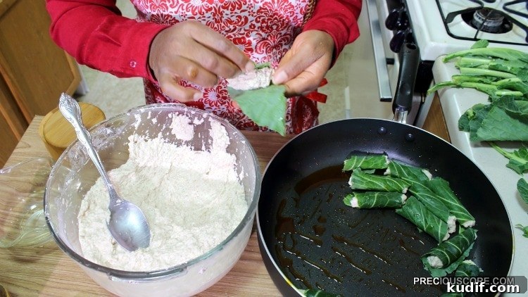 How to Make Authentic Ekwang: Step-by-Step Cameroonian Recipe 9 Wrapping ekwang in green leaves.