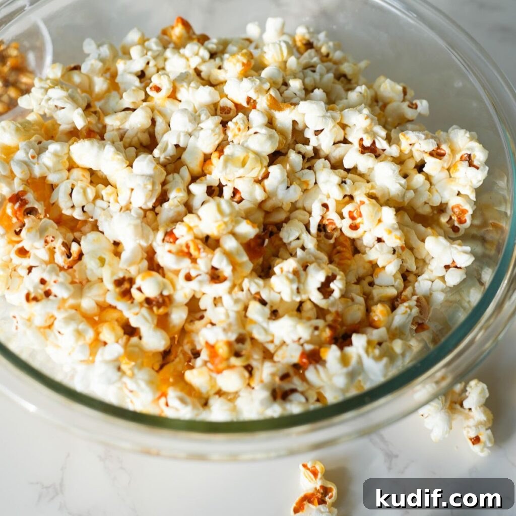 A bowl of homemade kettle corn with a sweet, crispy sugar coating and a touch of salt.