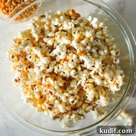 A bowl of homemade kettle corn with a sweet, crispy sugar coating and a touch of salt.
