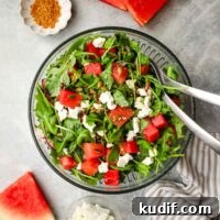 Refreshing Mexican Watermelon & Jicama Salad Recipe 11 A serving bowl of Mexican watermelon salad with serving utensils.