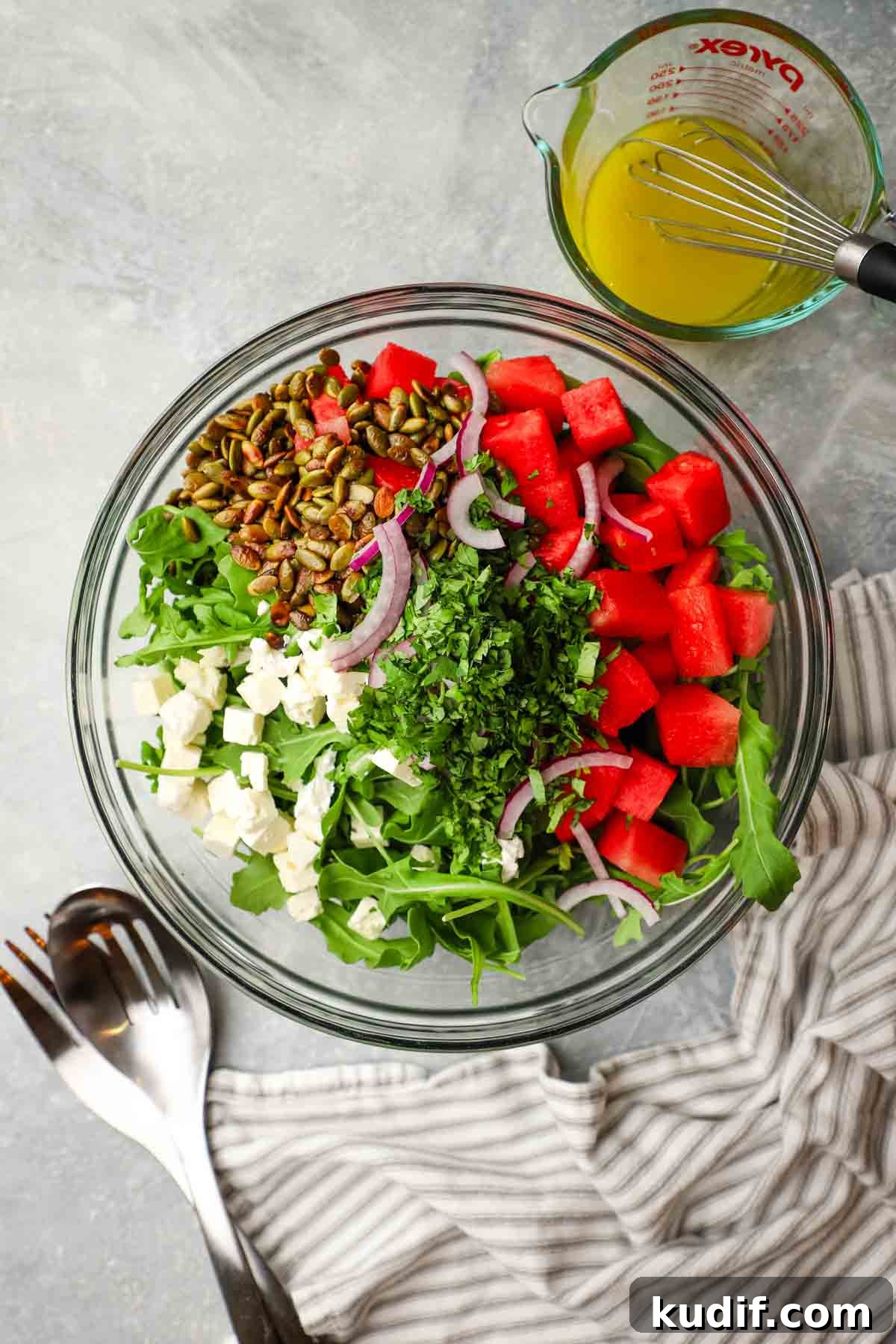 Refreshing Mexican Watermelon & Jicama Salad Recipe 3 overhead view of a bowl of mexican watermelon salad with the dressing on the side