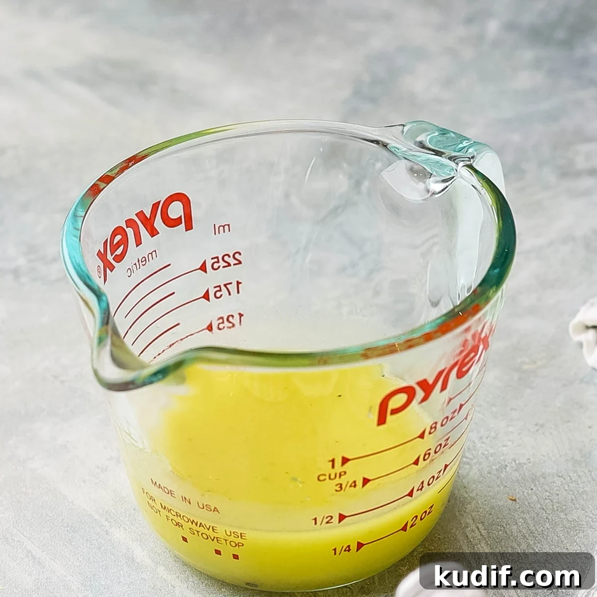 Refreshing Mexican Watermelon & Jicama Salad Recipe 7 a measuring cup with dressing