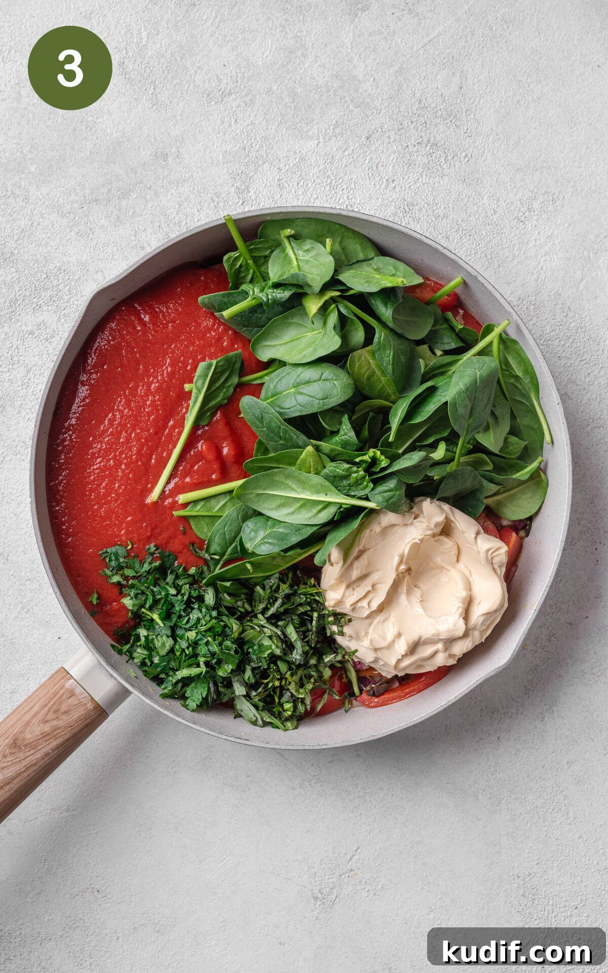 Tomato sauce and herbs in a skillet.