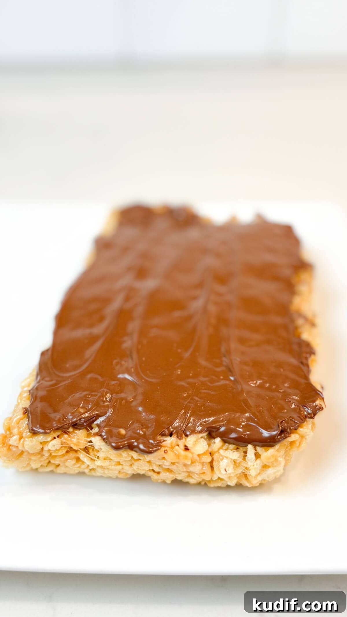 Peanut Butter Rice Krispie Treats Recipe for Gooey, Crunchy Squares 8 Treats topped with chocolate.
