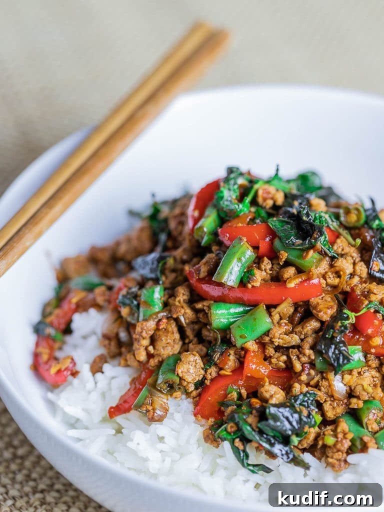 Vegetarian Thai Basil Tofu Stir Fry (Pad Krapow) in a white bowl with chopsticks