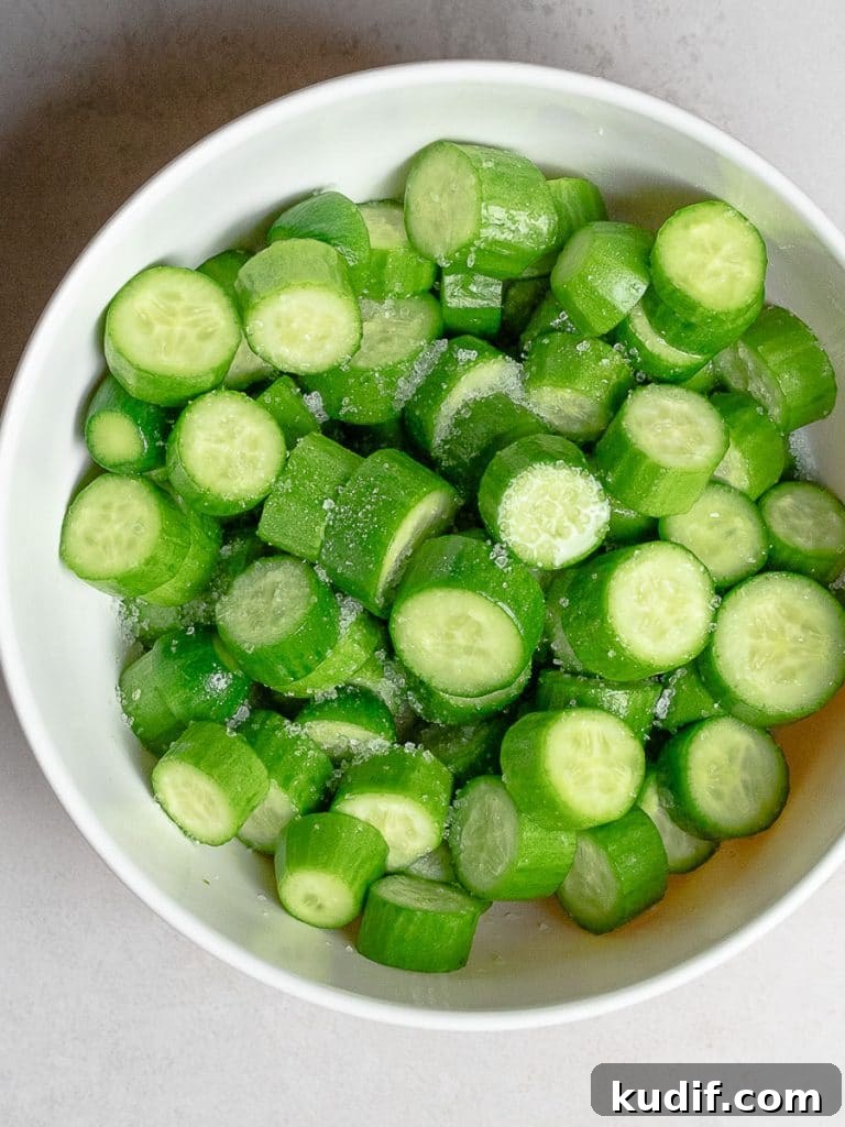 chopped persian cucumbers with salt in a bowl