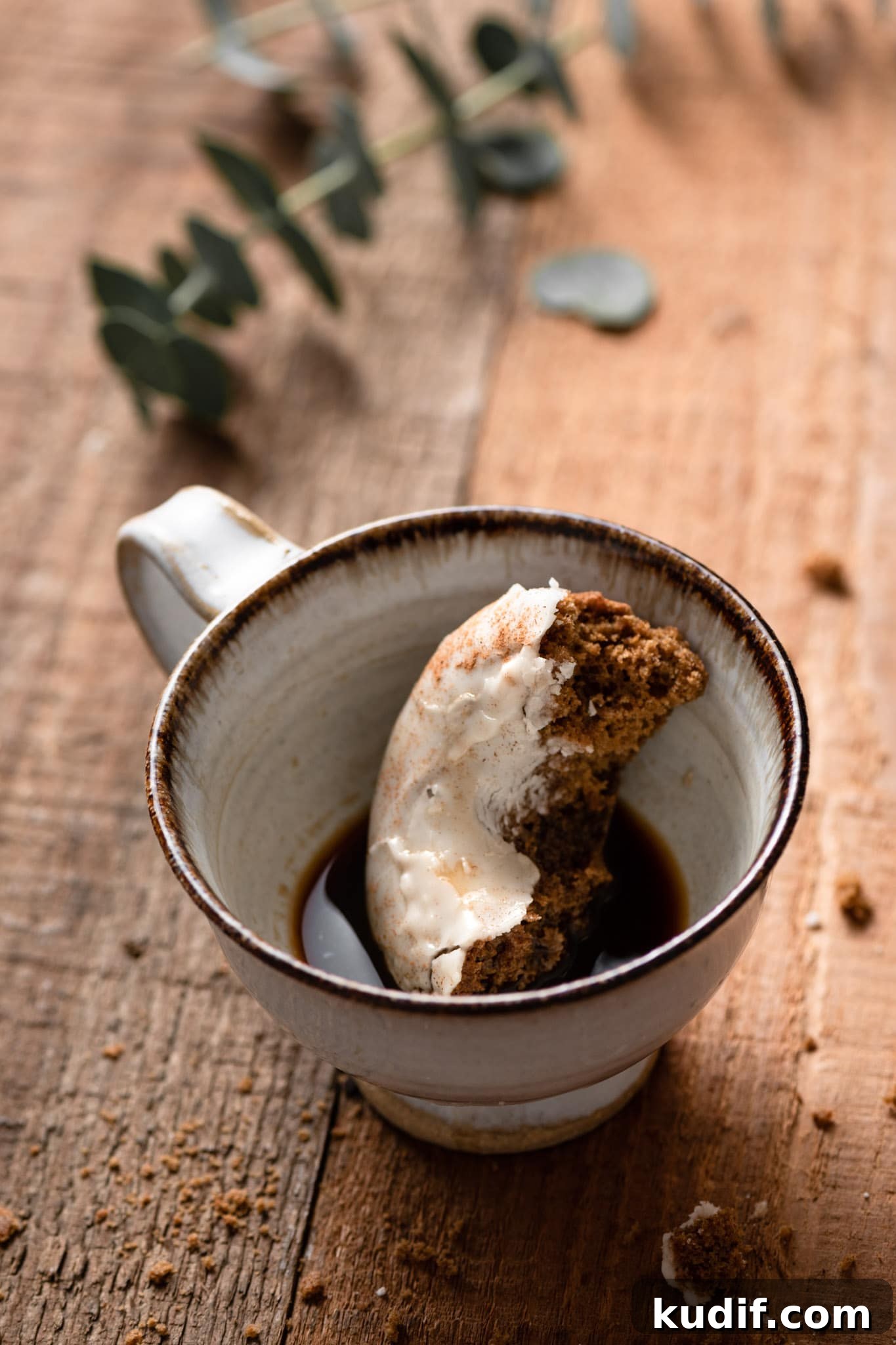 Baked Gingerbread Donuts with Vanilla Glaze 4 Gingerbread doughnut dunked into a cup of gingerbread coffee.