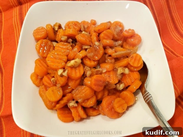 Orange Glazed Carrots - The Grateful Girl Cooks! The orange glazed carrots with pecans are served in a white bowl.