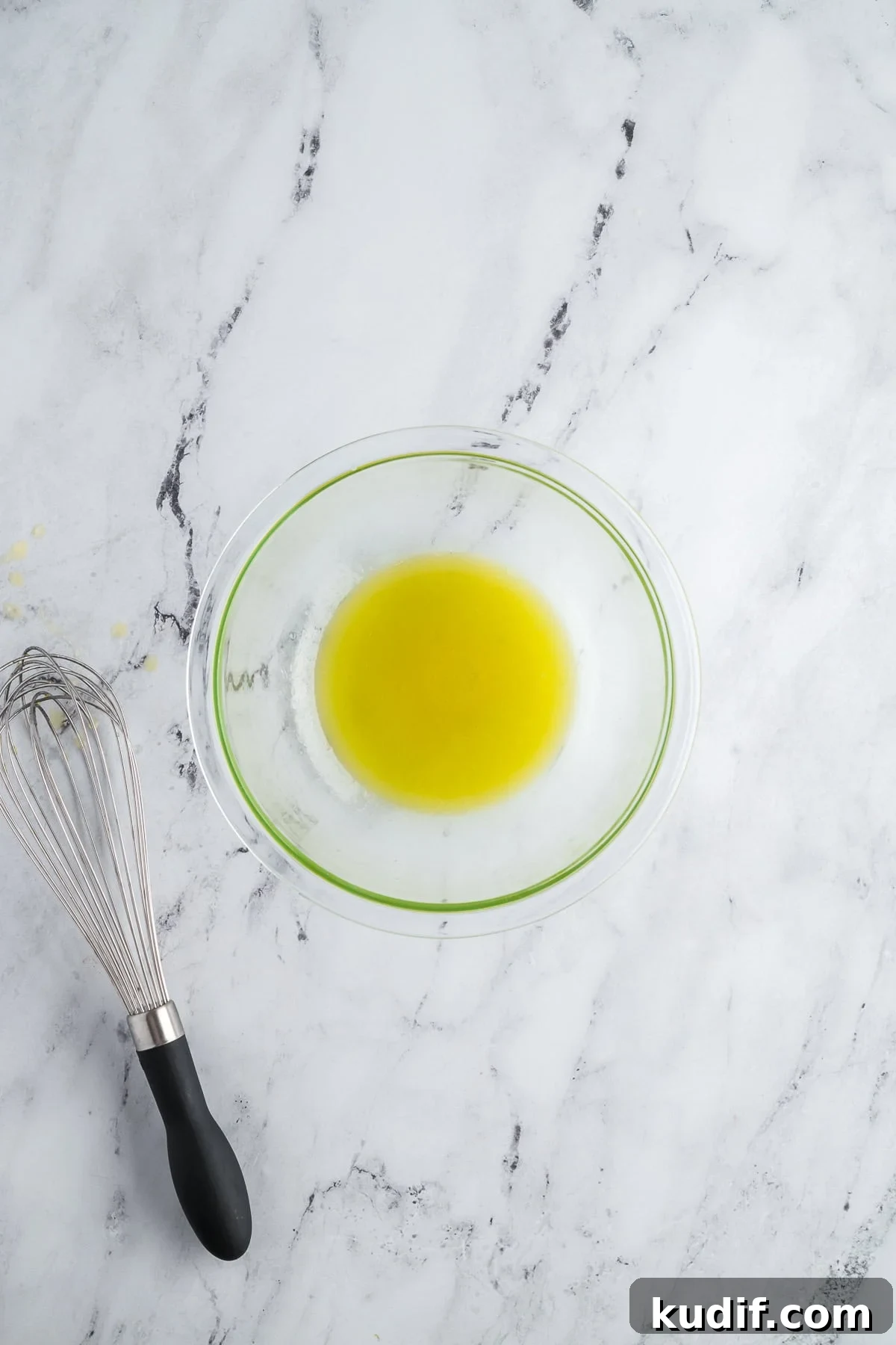 Lemon juice, olive oil, and honey whisked together in a small bowl to make a vinaigrette.