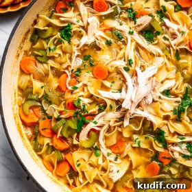 Overhead image of a pot full of turkey noodle soup.