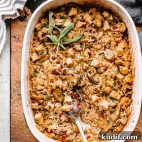 turkey wild rice casserole in a baking dish with a big spoon.