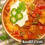 Instant Pot Red Pork Chili Recipe — Quick Pressure Cooker Meal 8 Instant Pot Pressure Cooker Red Pork Chili in a bowl with ganishings on a gray striped napkin.
