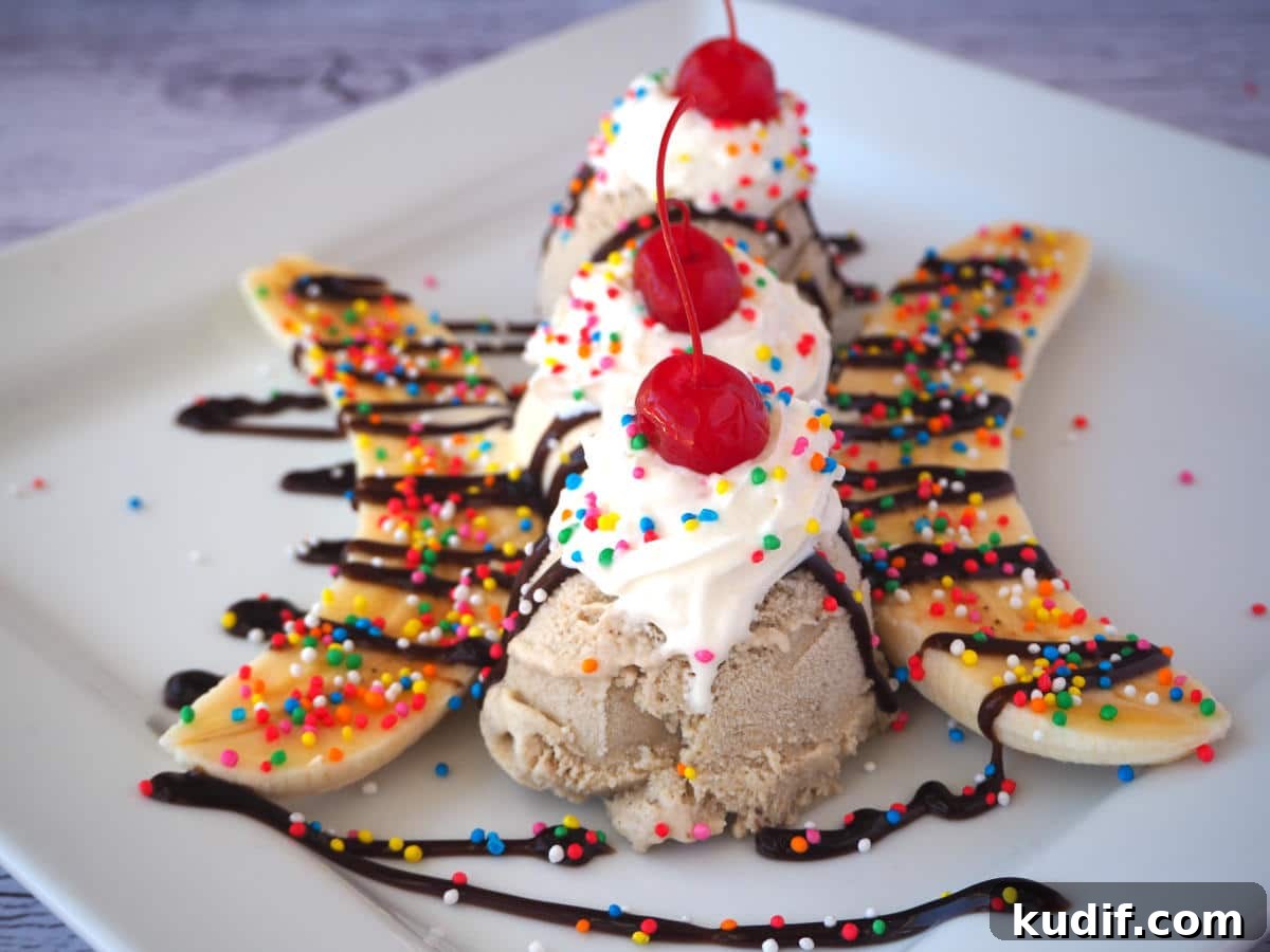 Classic Banana Split Recipe | Step-by-Step Dessert Guide 12 End view of banana split with scoops, sliced banana, chocolate sauce, whipped cream, nuts, sprinkles and cherries.
