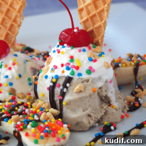 Classic Banana Split Recipe | Step-by-Step Dessert Guide 14 Close up side view of banana split with banana ice cream, sliced banana, chocolate sauce, whipped cream, nuts, sprinkles and cherry.