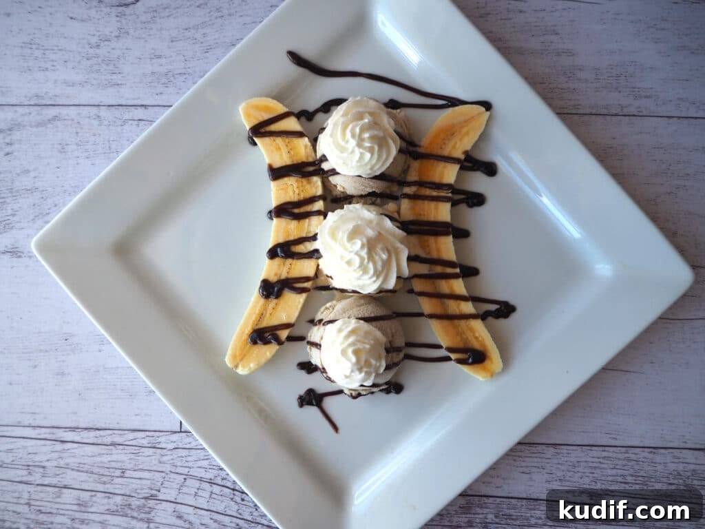 Classic Banana Split Recipe | Step-by-Step Dessert Guide 9 Top down view adding whipped cream.