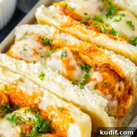 Slow Cooker Chicken Parmesan Subs Recipe for Perfect Sandwiches 6 Angle shot of chicken parm meatball subs on a tray