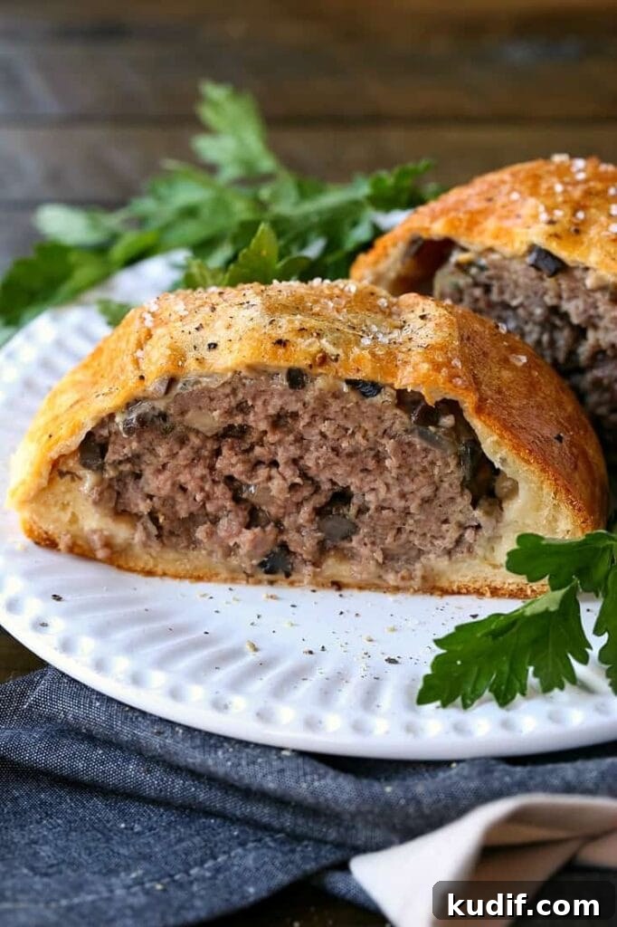 ground beef wellington sliced in half