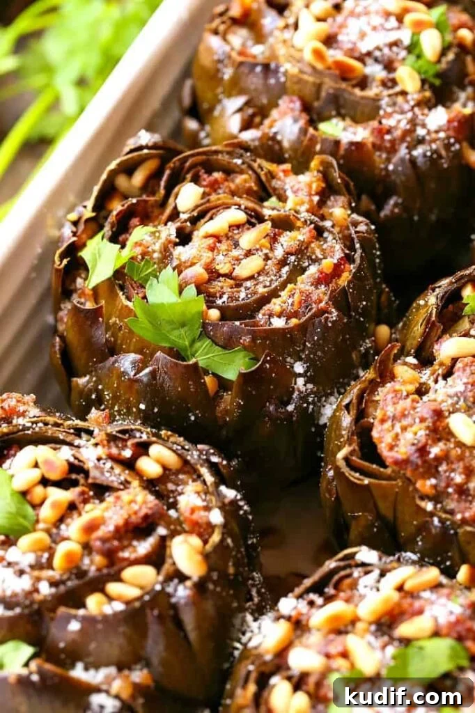 Grandma's Best Stuffed Artichokes are a side dish stuffed with sausage, cheese and pine nuts