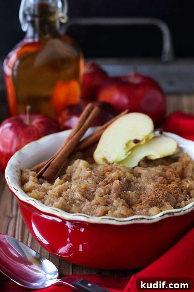 Homemade applesauce in a dish with cinnamon sticks