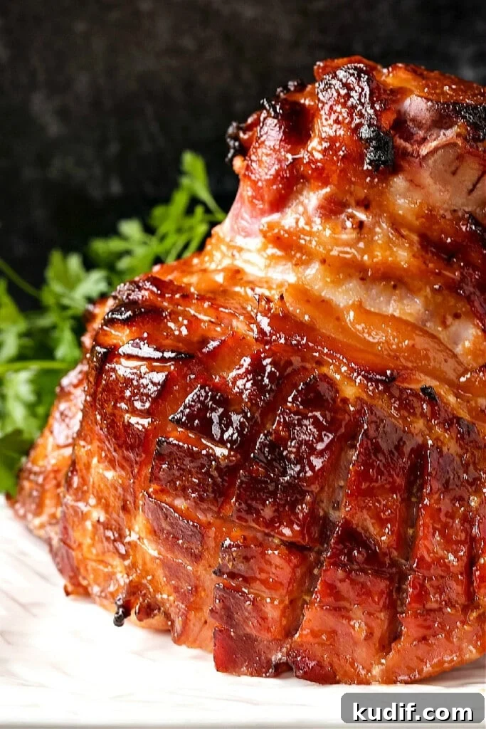 whole baked ham on platter with parsley