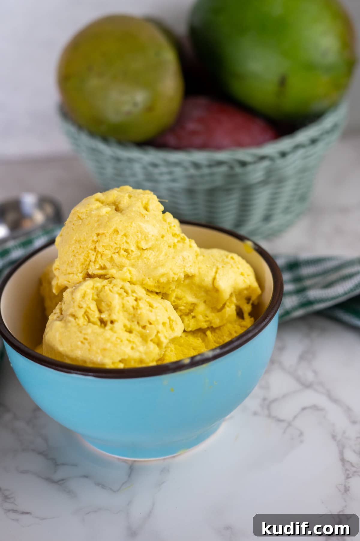 Creamy Homemade Mango Ice Cream Recipe in 30 Minutes 8 mango ice cream in blue bowl