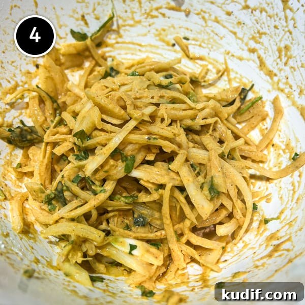 Crispy Onion Pakoda Recipe: Indian Onion Fritters Guide 5 Onion pakoda batter mix in a bowl