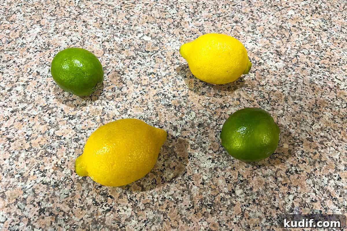 Can You Put Citrus Peels Down the Garbage Disposal? 3 Lemons and limes sitting on a counter.